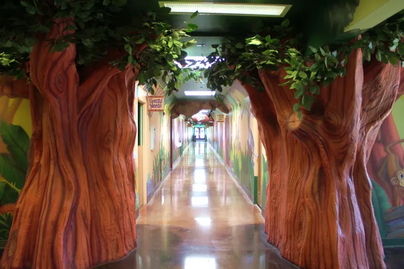 A hallway inside Treasure Island decorated with sculpted trees